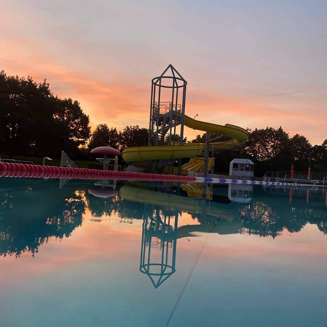 Abendsonne spiegelt sich im Wasser des Freibades
